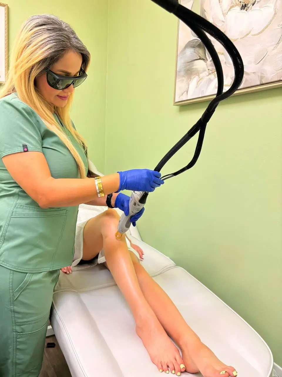 Close view of a laser handpiece treating the lower leg